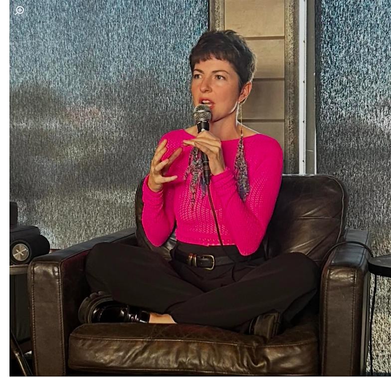 Melanie Wild speaking on stage