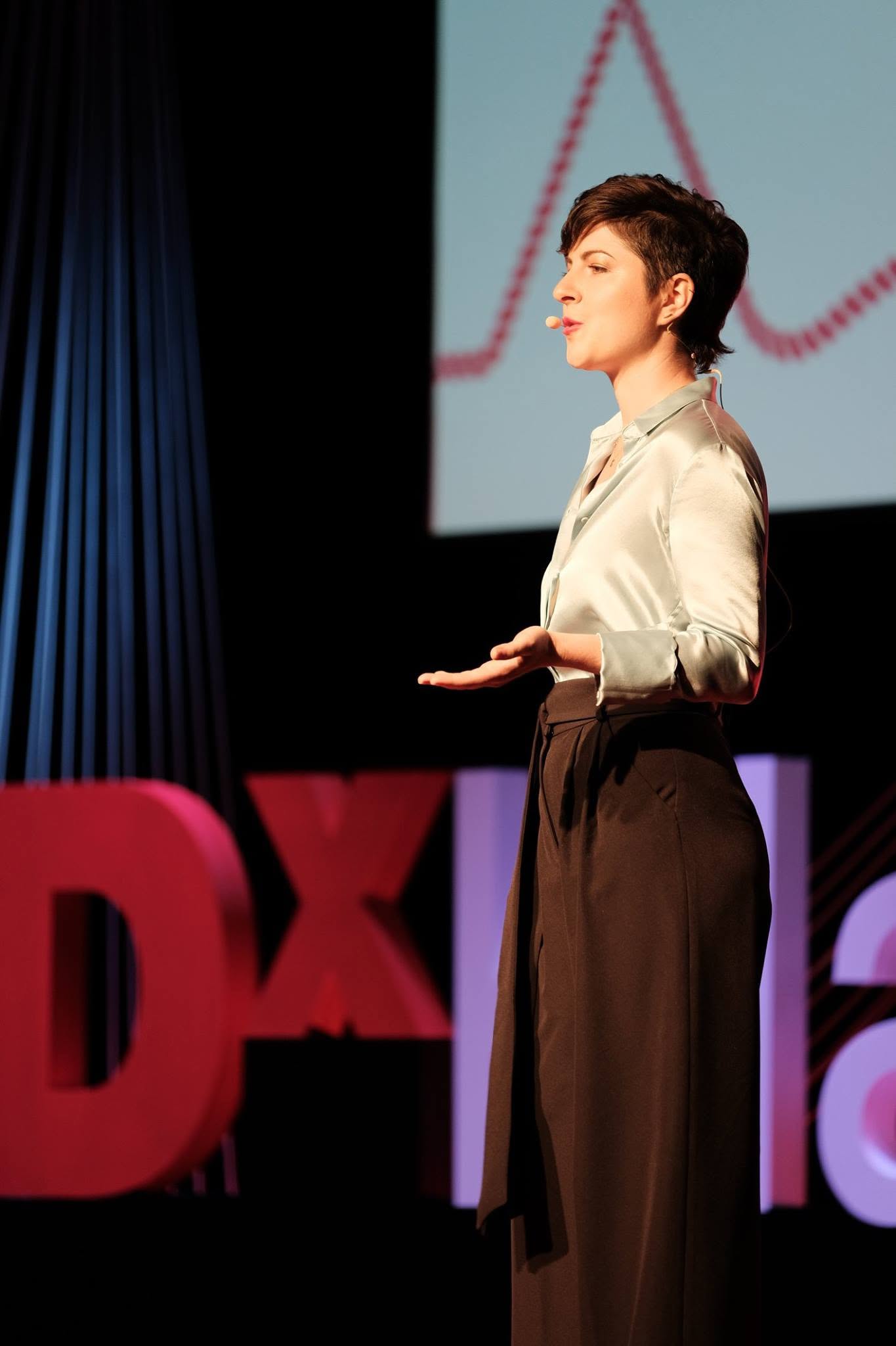 Melanie Wild speaking on the TEDx stage