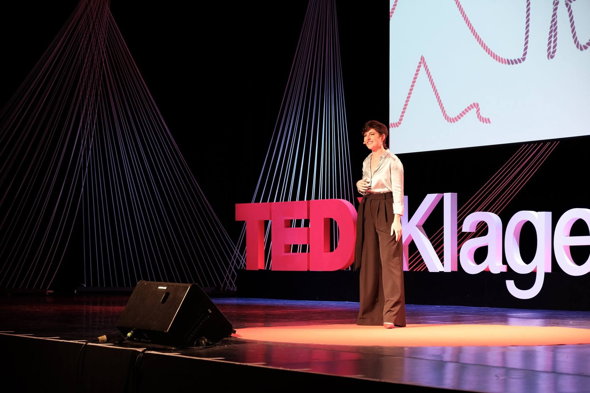 Melanie Wild speaking on the TEDx stage